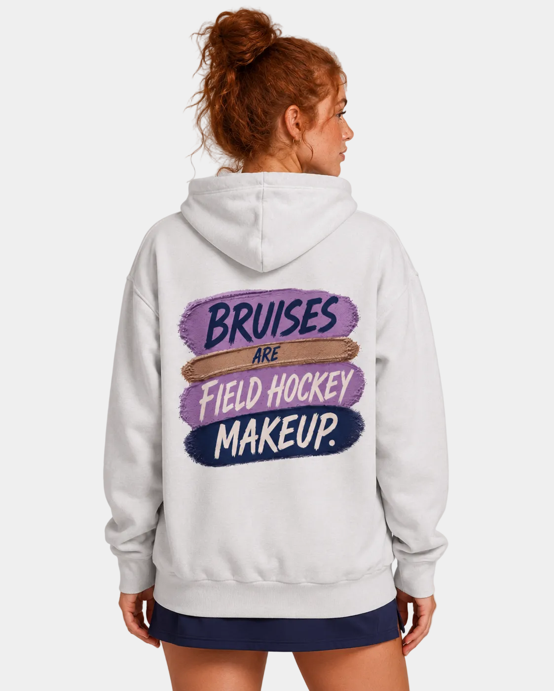 Woman wearing a hoodie with 'Bruises are Field Hockey Makeup' text on the back.