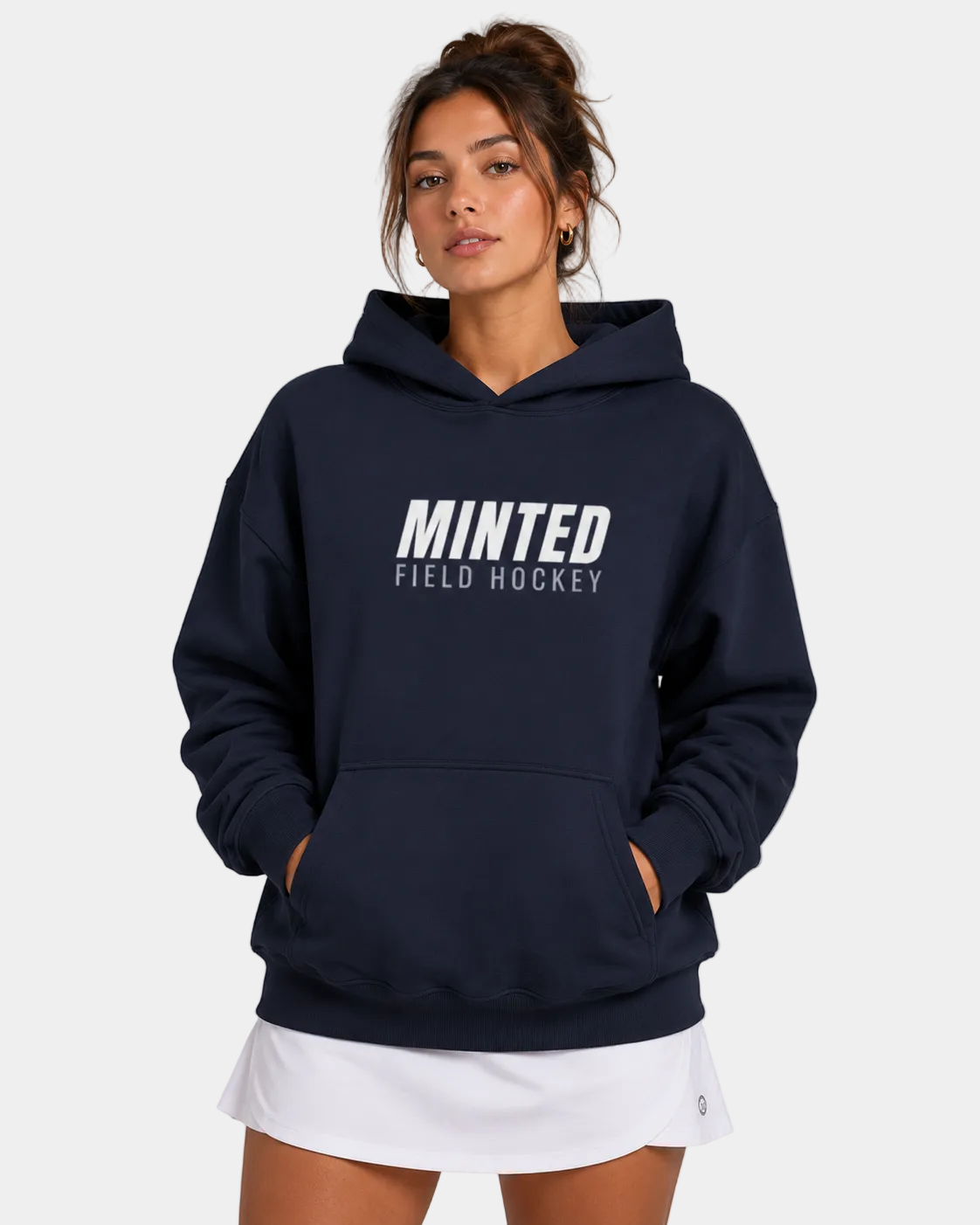 Person wearing a navy hoodie with 'Minted Field Hockey' text on a plain background