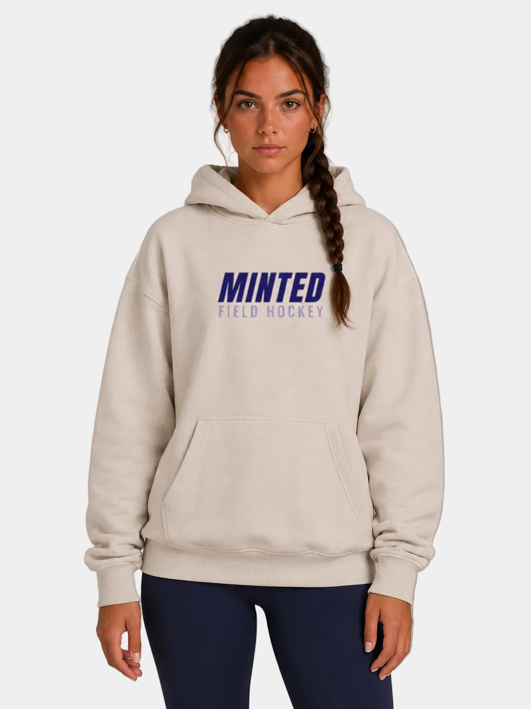 Woman wearing a beige hoodie with 'Minted Field Hockey' text on a gray background