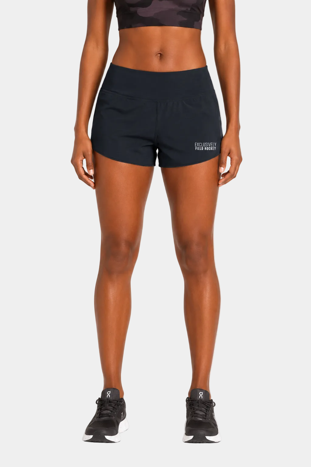 Women's field hockey performance shorts in True Navy with white embroidered Exclusively Field Hockey logo. Lightweight athletic shorts for field hockey training, practice, tournaments, and everyday wear.