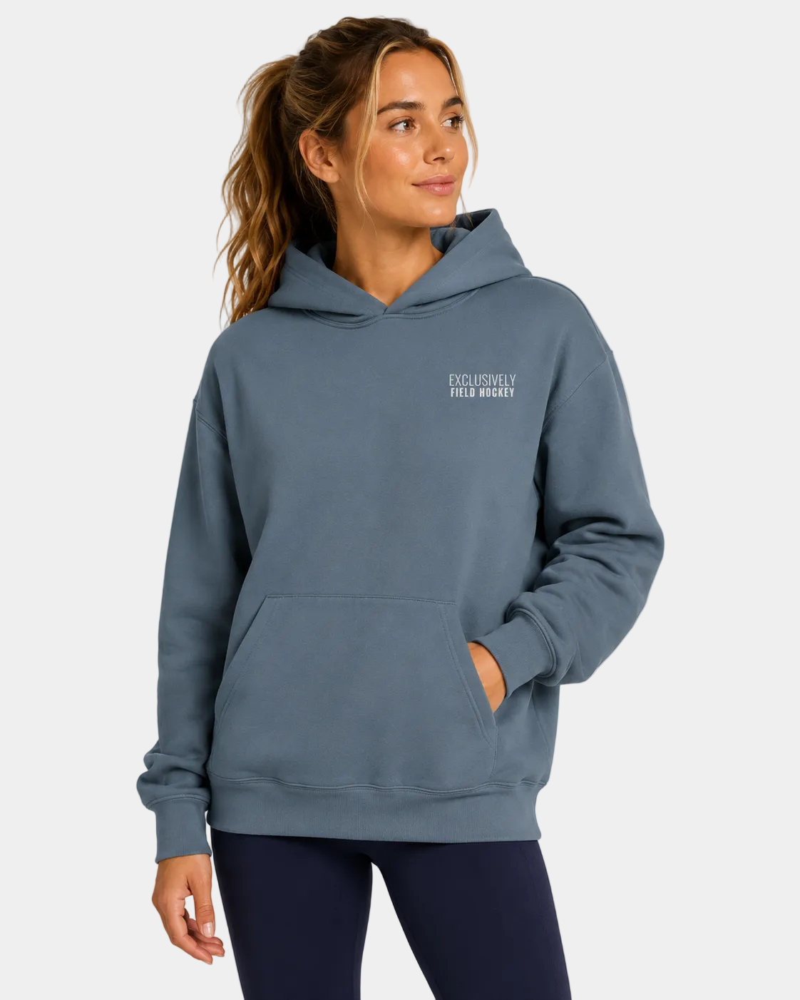 Women's field hockey ultra heavyweight hoodie in Blue Magic with embroidered Exclusively Field Hockey logo. Premium oversized fleece hoodie for field hockey players, training, tournaments, and everyday wear.