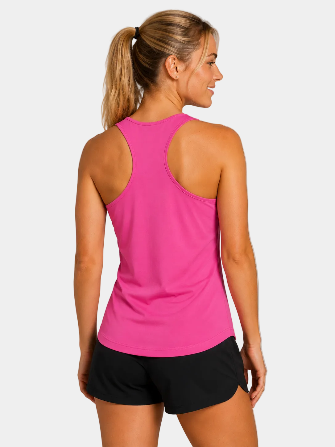 Women's field hockey racerback tank in Neon Pink facing back to camera. Lightweight moisture-wicking performance tank for field hockey forwards, midfielders, defenders, and athletes.